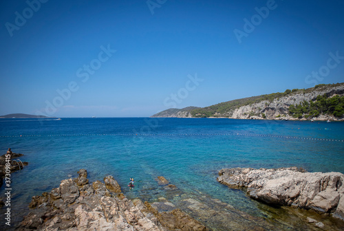 Beautiful turquoise sea at Hvar island, Croatia, with steep rocky cliffs towering above the water © Miroslav Posavec