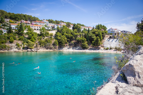 Beautiful Podstine beach at the Hvar island, Croatia, famous for its turquoise water and steep hills and houses surrounding the bay