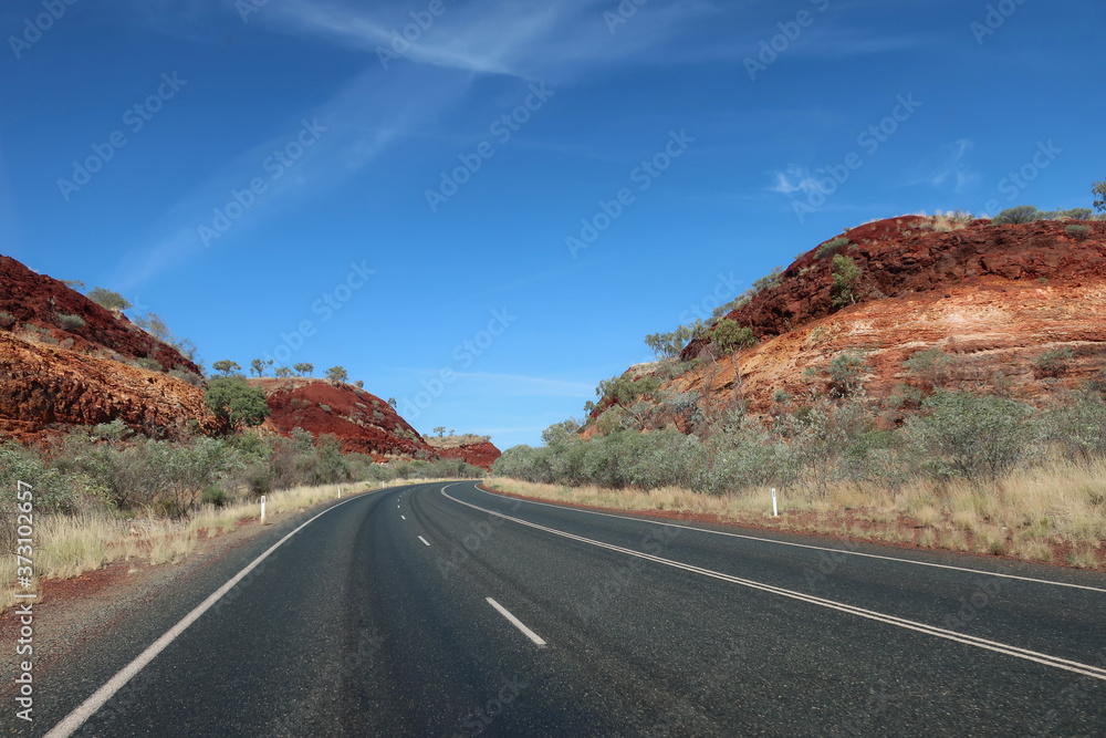 Straße durch rote Felsen im Outback Australien Straße durch rote Felsen im Outback Australien