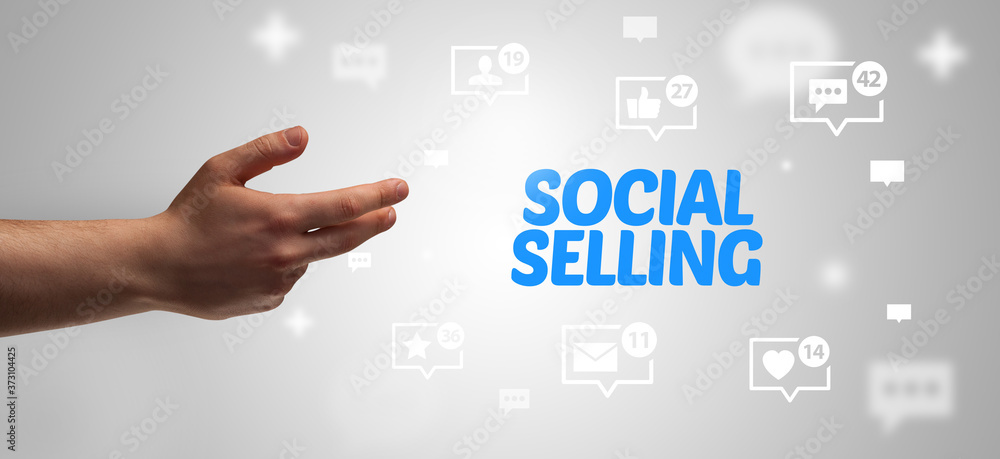Close-Up of cropped hand pointing at SOCIAL SELLING inscription, social networking concept Close-Up of cropped hand pointing at SOCIAL SELLING inscription, social networking concept