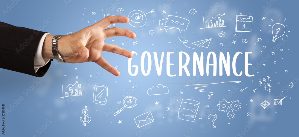 Close-Up of cropped hand pointing at GOVERNANCE inscription, modern business solution concept Close-Up of cropped hand pointing at GOVERNANCE inscription, modern business solution concept