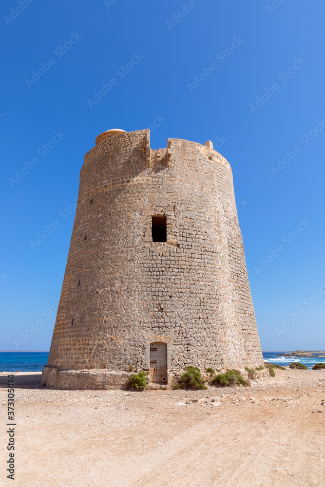 View of the old observation tower Torre De Ses Portes on the coast of the Ibiza island.