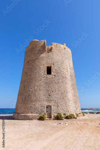 View of the old observation tower Torre De Ses Portes on the coast of the Ibiza island.