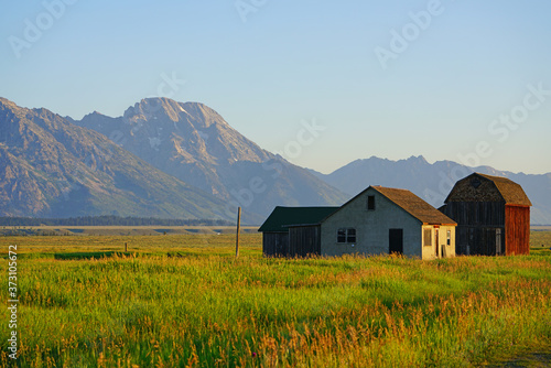 Sunrise over Mormon Row in Grand Teton National Park with the mountains in the background in Wyoming, United States