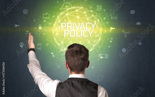Rear view of a businessman with PRIVACY POLICY inscription, online security concept