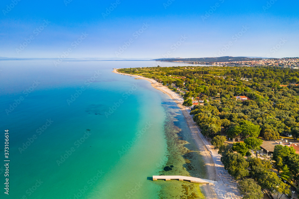 Croatia, island of Pag, beautiful touristic resorts, long beaches under pine trees, Adriatic Sea on sunny summer day. Aerial drone view. Croatia, island of Pag, beautiful touristic resorts, long beaches under pine trees, Adriatic Sea on sunny summer day. Aerial drone view.