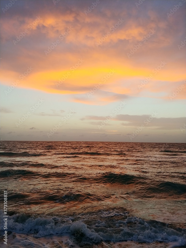 Mango Color Clouds in Sky at Ocean
