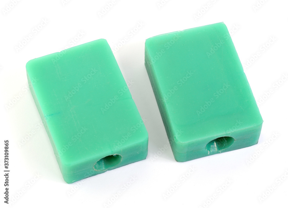 Fototapeta premium Rubber or silicone molds are used to inject green wax to produce a large amount of jewelry in a jewelry factory placed on a white background.
