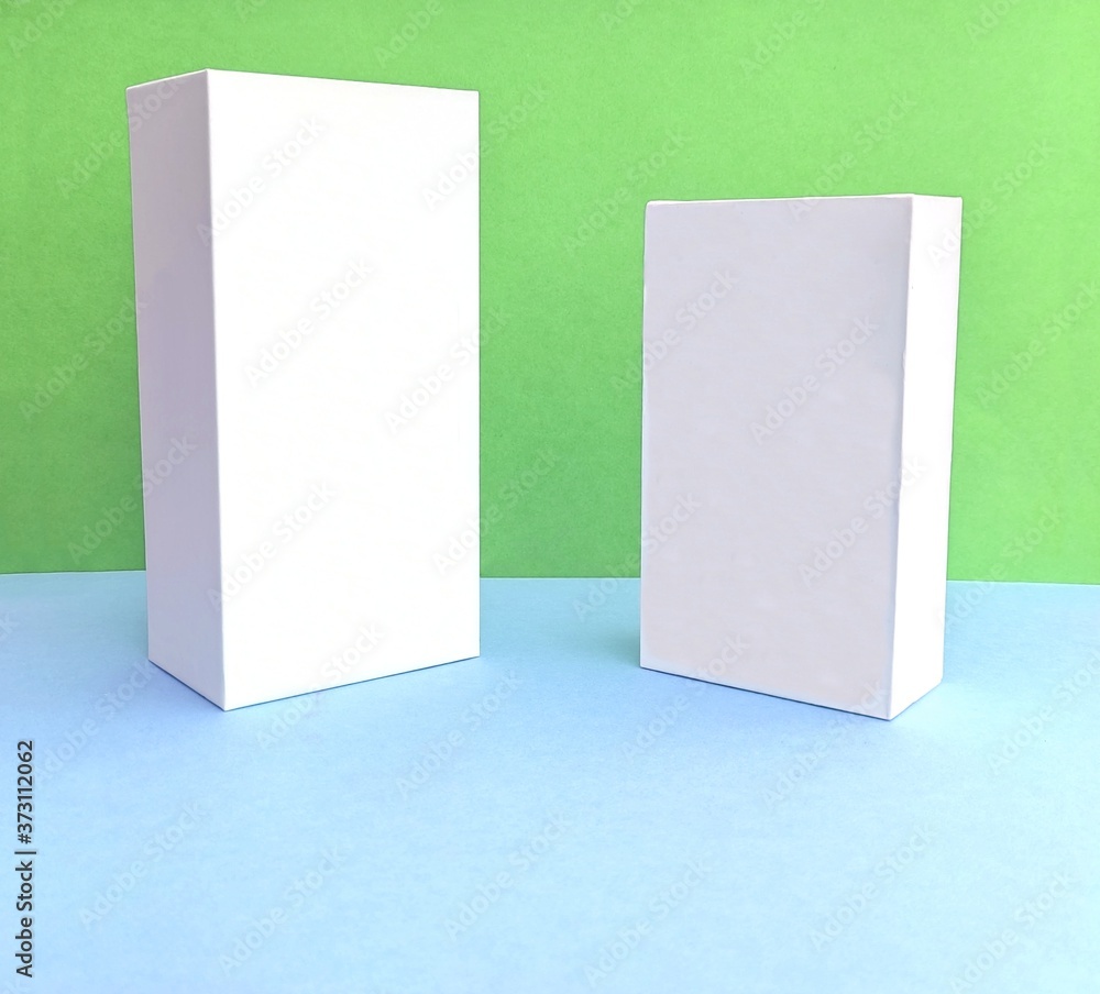 Front view of two white rectangular boxes on a pastel background for mock-up, it's real photo, not 3D render. Trendy product stand display showcase for cosmetic products and goods. Copy space. Front view of two white rectangular boxes on a pastel background for mock-up, it's real photo, not 3D render. Trendy product stand display showcase for cosmetic products and goods. Copy space.
