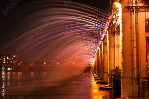 Amazing fantastic colorful fountain with blight at the bridge 