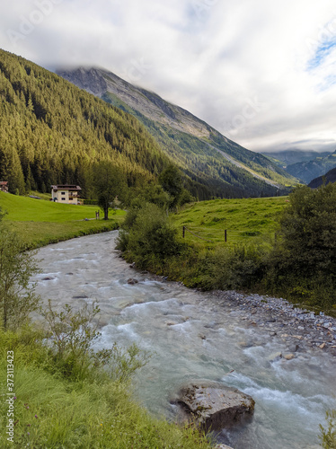 View to Tuxertal valley with Tux river and Zillertal alps near village Juns and Hintertux glacier in summer, Tirol Austria Europe photo