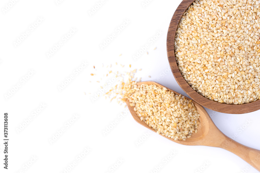 Closeup white sesame seeds in wooden bowl scoop isolated on white Closeup white sesame seeds in wooden bowl scoop isolated on white