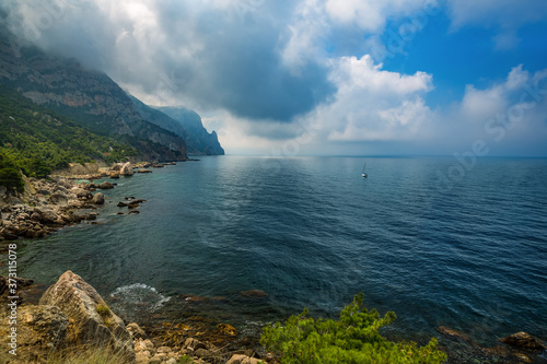 Sea and mountains in the clouds. Beautiful sea natural landscape, travel.
