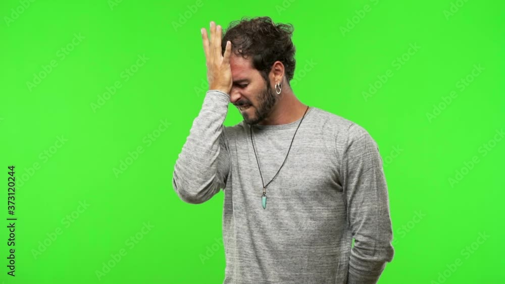 young man on chroma green screen forgetful, realize something young man on chroma green screen forgetful, realize something