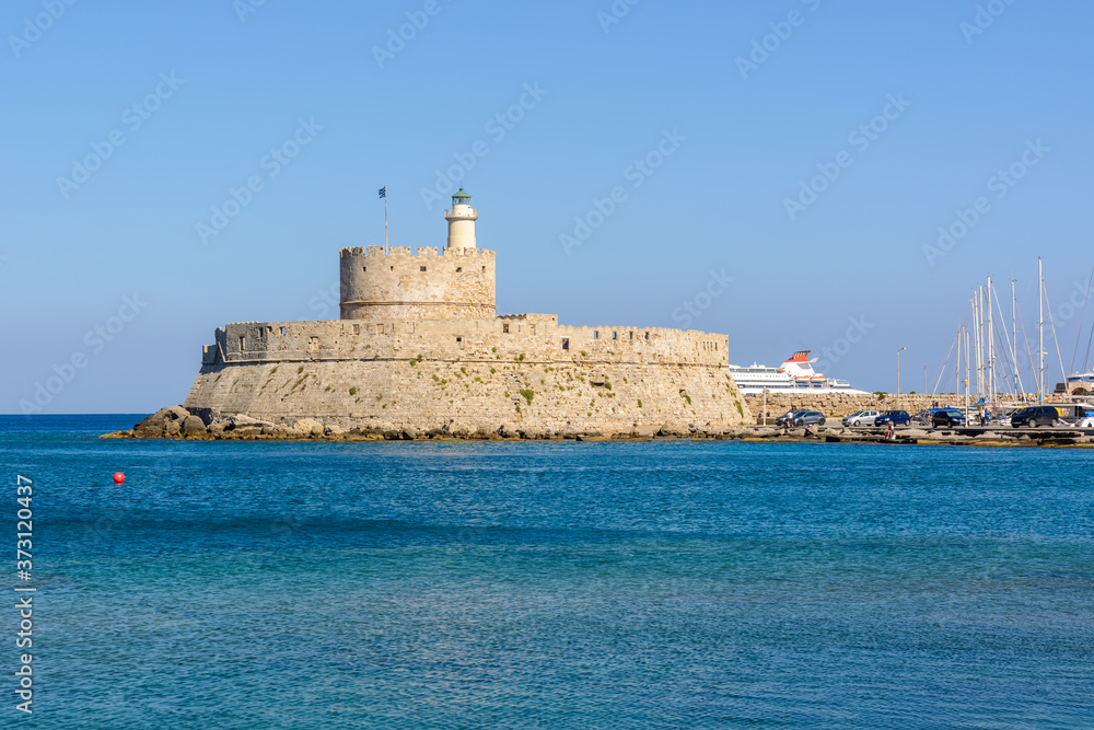 Fort of St. Nicholas with lighthouse in Mandraki harbor. Rhodes island, Greece