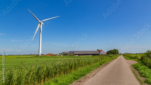 Modern open farm with his own wind turbine in the Netherlands