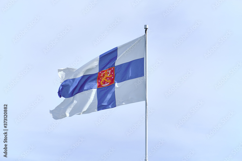 Flag of Finland with on a white flagpole.