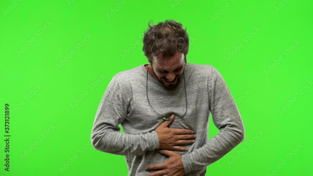 young man on chroma green screen laughing and having fun young man on chroma green screen laughing and having fun