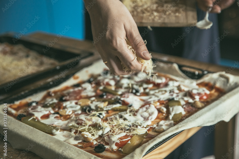 Hand with cheese. Preparing of pizza at the home. Cheese for the homemade pizza.
Pizza time. Hand with cheese. Preparing of pizza at the home. Cheese for the homemade pizza.
Pizza time.