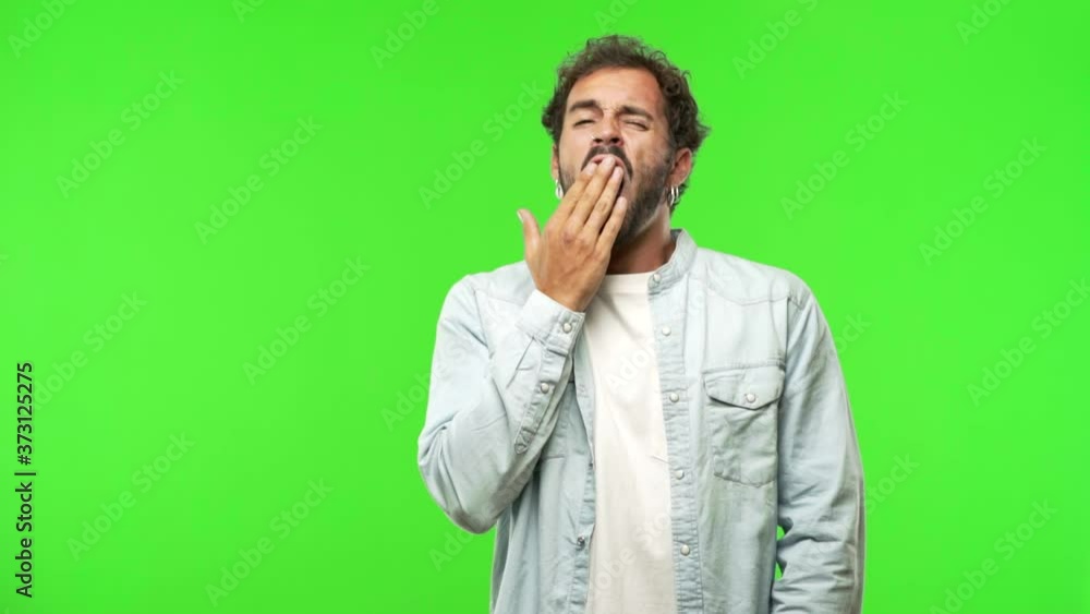 young man on chroma green screen tired and very sleepy young man on chroma green screen tired and very sleepy
