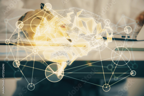 Multi exposure of woman's writing hand on background with brain hologram. Concept of brainstorming.