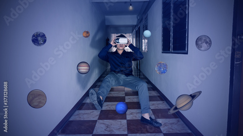 A young man watching through a 3D glasses and with many stars around, taken from NASA.