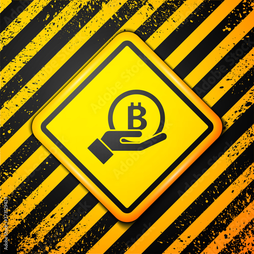 Black Hand holding Bitcoin icon isolated on yellow background. Blockchain technology, digital money market, cryptocoin wallet. Warning sign. Vector.