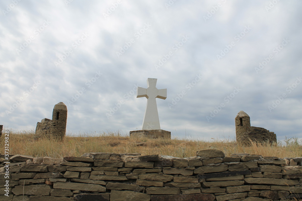 The memorial stone cross in the steppe The memorial stone cross in the steppe
