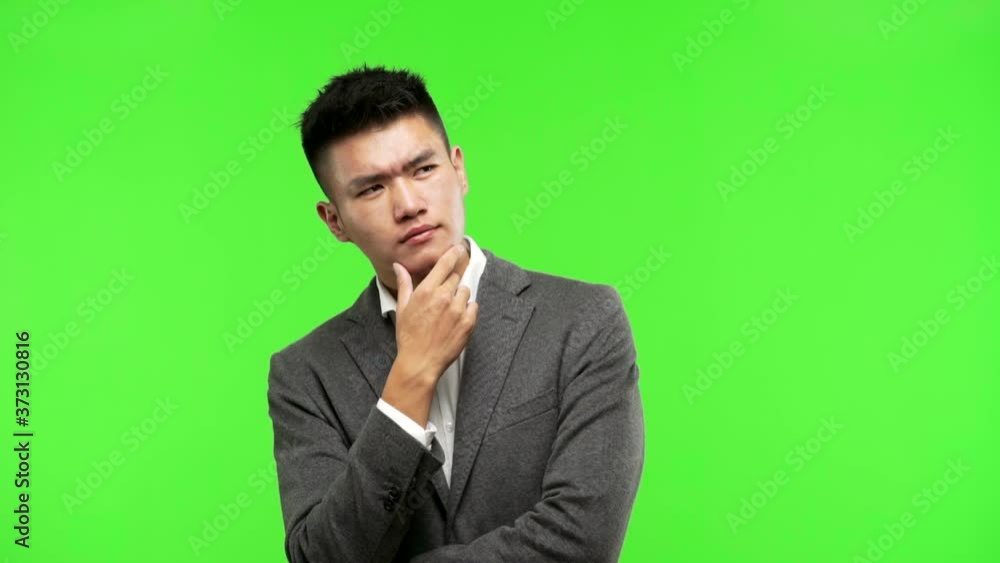 Young chinese business man thinking about an idea Young chinese business man thinking about an idea