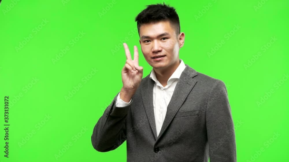 Young chinese business man fun and happy doing a gesture of victory Young chinese business man fun and happy doing a gesture of victory