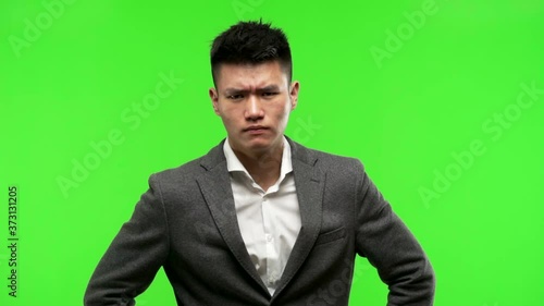 Young chinese business man scolding someone very angry