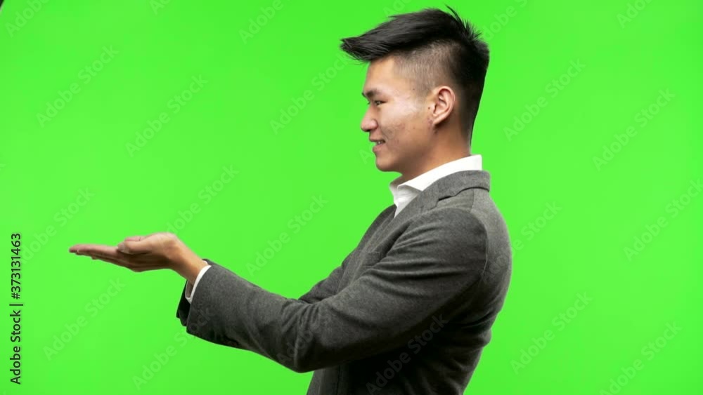 Young chinese business man holding something with hands Young chinese business man holding something with hands