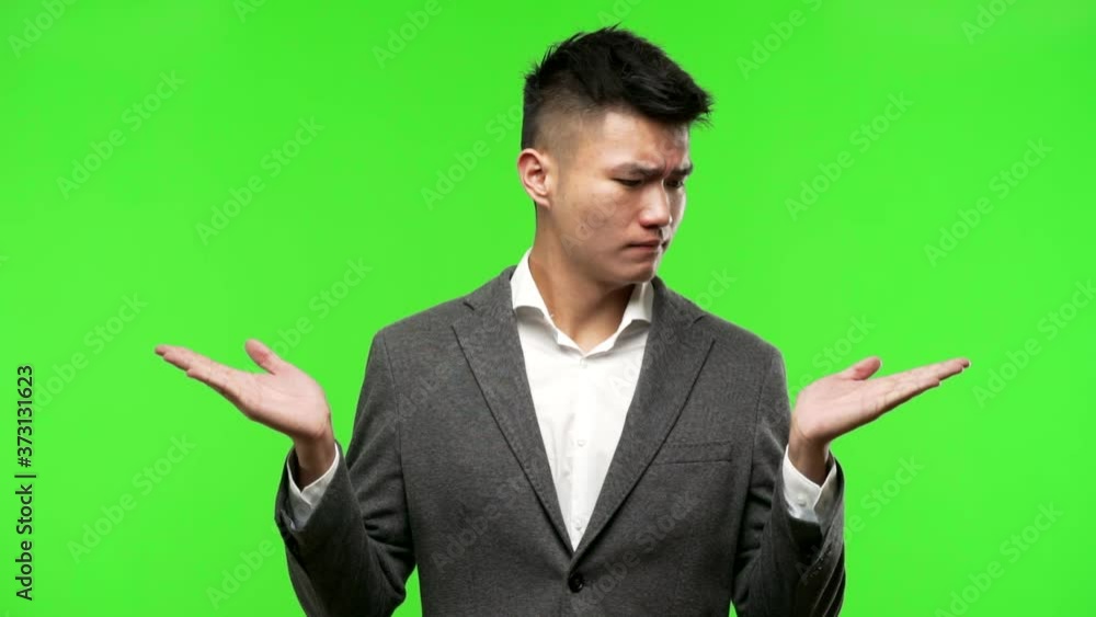 Young chinese business man confused and doubtful Young chinese business man confused and doubtful
