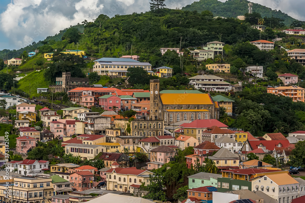 Colourful houses and a church line a hill in St Georges in Grenada