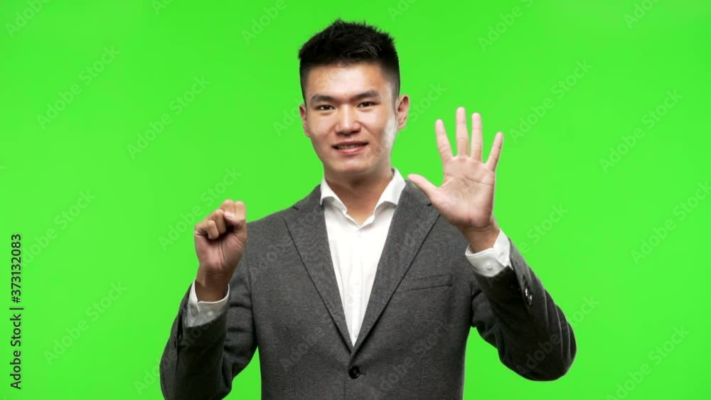 Young chinese business man showing number eight Young chinese business man showing number eight