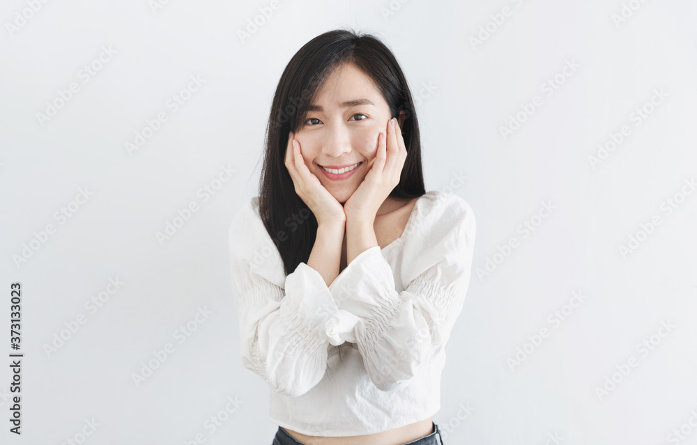 Happy Asian woman touching face with smiling face, on white background Happy Asian woman touching face with smiling face, on white background