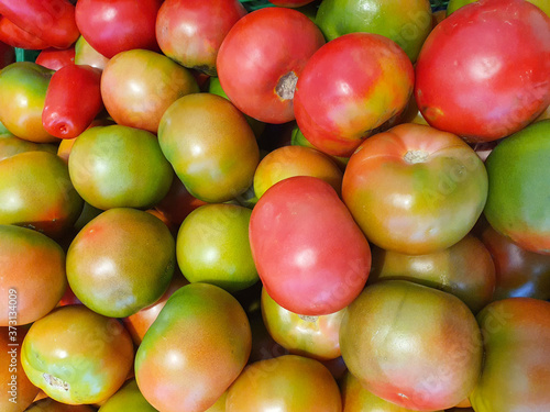 Italian red and green tomatoes grouped for sale