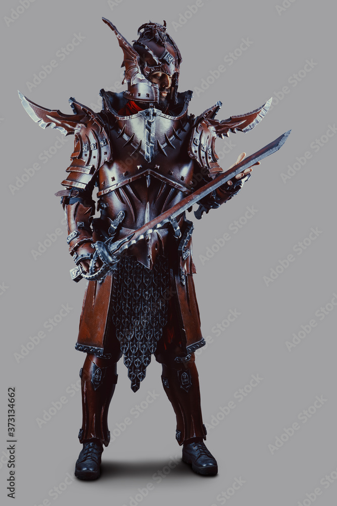 Powerful knight in armor with the sword. Isolated over grey background. Powerful knight in armor with the sword. Isolated over grey background.