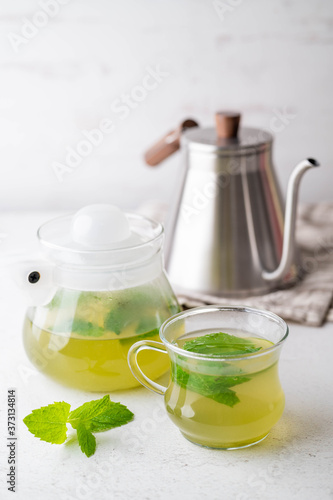 green hot mint tea in glass cup