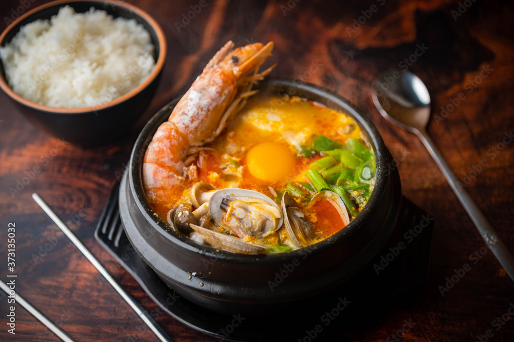 Sundubu, korean hot stone pot with tofu and seafood Sundubu, korean hot stone pot with tofu and seafood