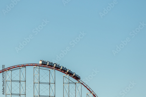 A roller coaster at the top of a hill
