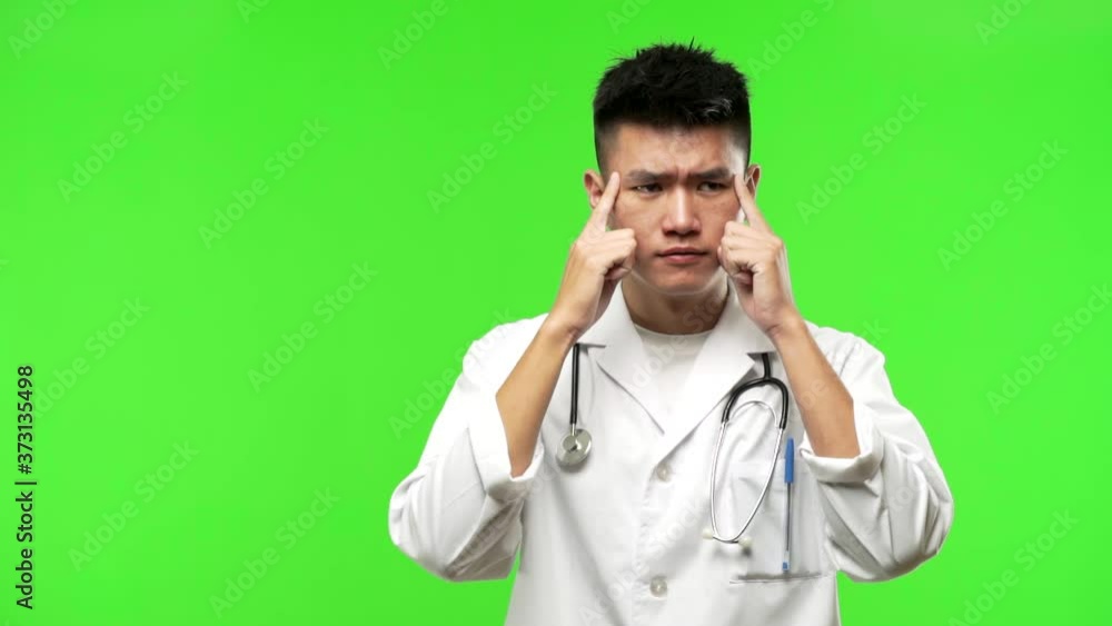 Young chinese doctor man making a concentration gesture Young chinese doctor man making a concentration gesture