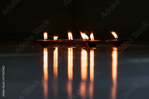  oil lamp or Diwali Diya also known as diva made of clay glowing decoration in diwali festival in front of flat. Diwali is biggest festival of India. Diwali is festival of lights and happiness. 