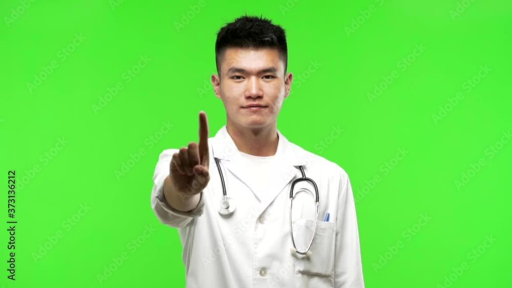 Young chinese doctor man showing number one Young chinese doctor man showing number one