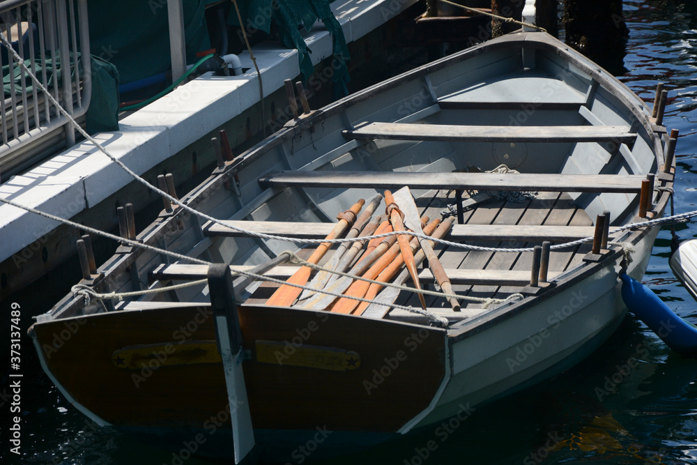 Photograph of a Row boat tied to the pier Photograph of a Row boat tied to the pier