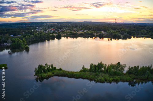 Lake near the forest and the city in the background