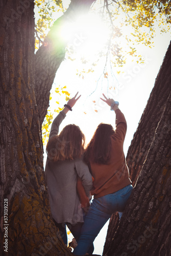 Best Friend Teenage Girls Fall at Lake Peace Sign © Jennifer