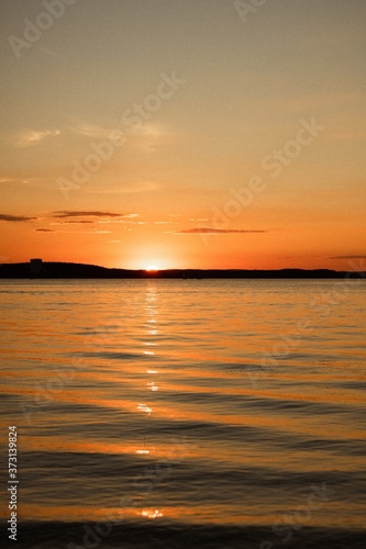 Beautiful orange sunset over the sea © Elena