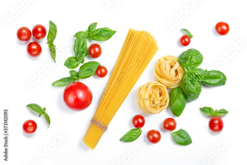 Cherry tomatoes, spaghetti and basil leaves on a white isolated background. Ingredients for pasta. Flat lay.