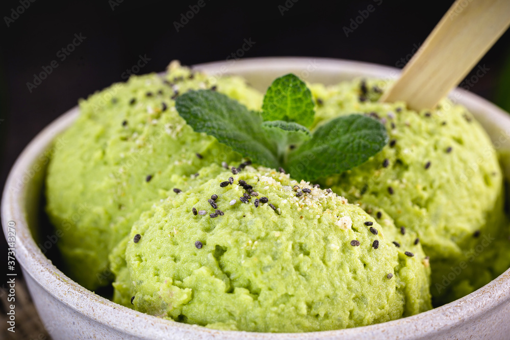 Homemade organic green avocado ice cream ready to eat, with mint leaf decorating. Homemade organic green avocado ice cream ready to eat, with mint leaf decorating.